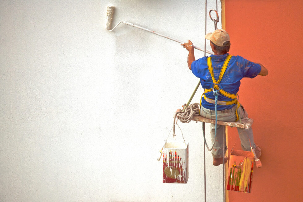 Painter working on an exterior wall